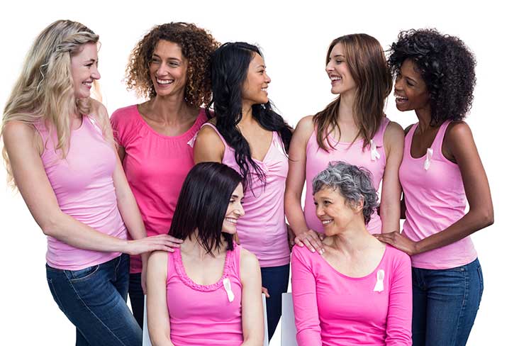 Seven women of different backgrounds and ages wearing pink