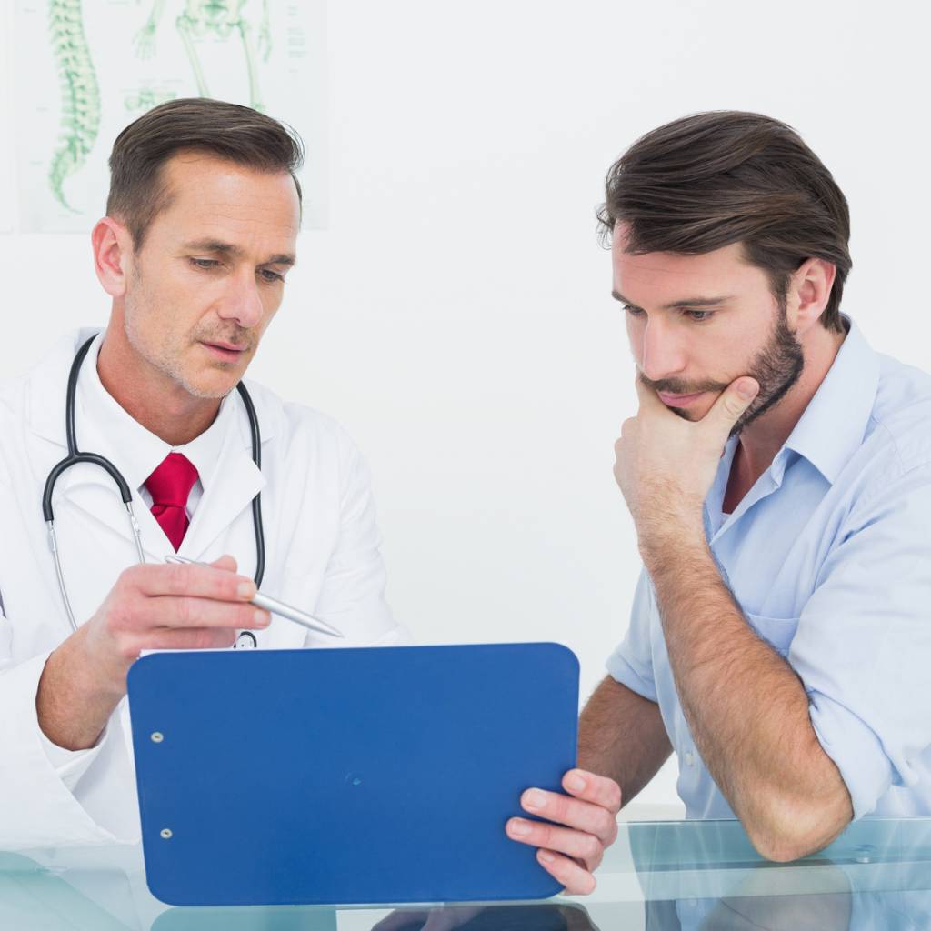 Male patient and male doctor discussing chart